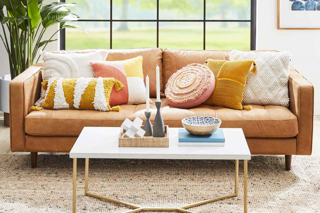 use different size and color of cushion to decorate a living room on a budget