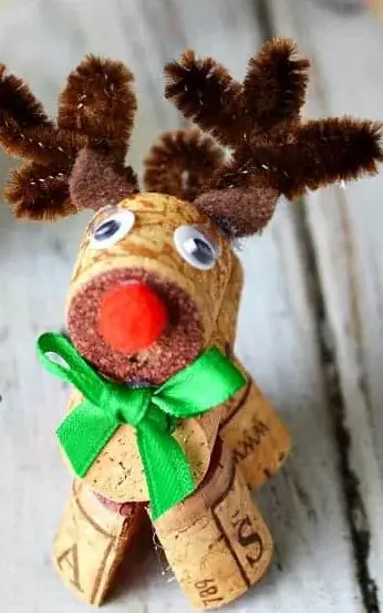 Cute reindeer ornaments to make from wine corks, with pipe cleaner antlers and tiny red pom-pom noses, a quick and easy holiday craft.