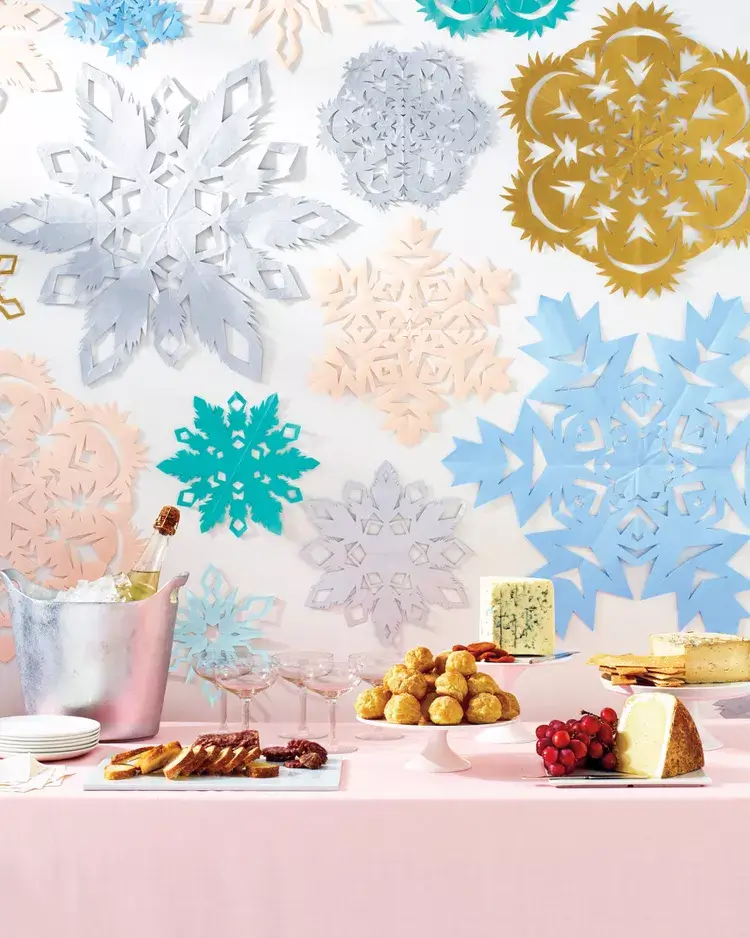  A collection of intricate, handmade paper snowflakes with intricate cut-out patterns, examples of easy and affordable DIY Christmas decorations.