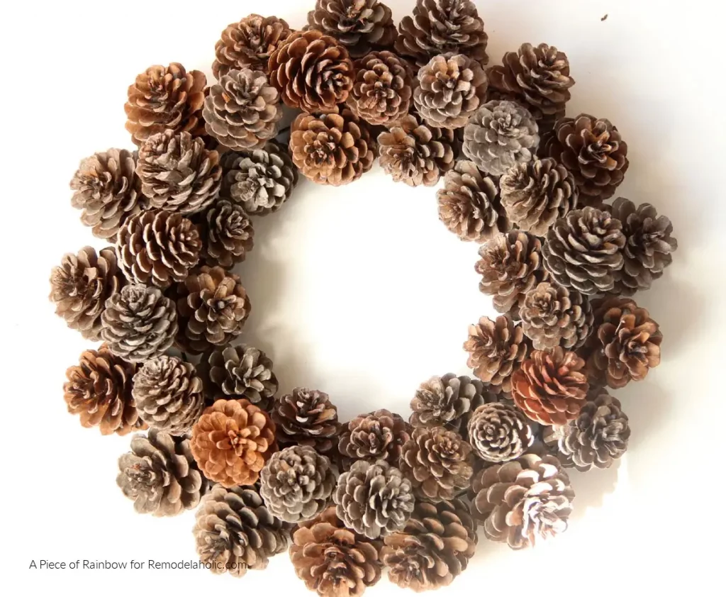 A natural Christmas wreath crafted from pinecones, a rustic DIY Christmas decorations idea for your front door.