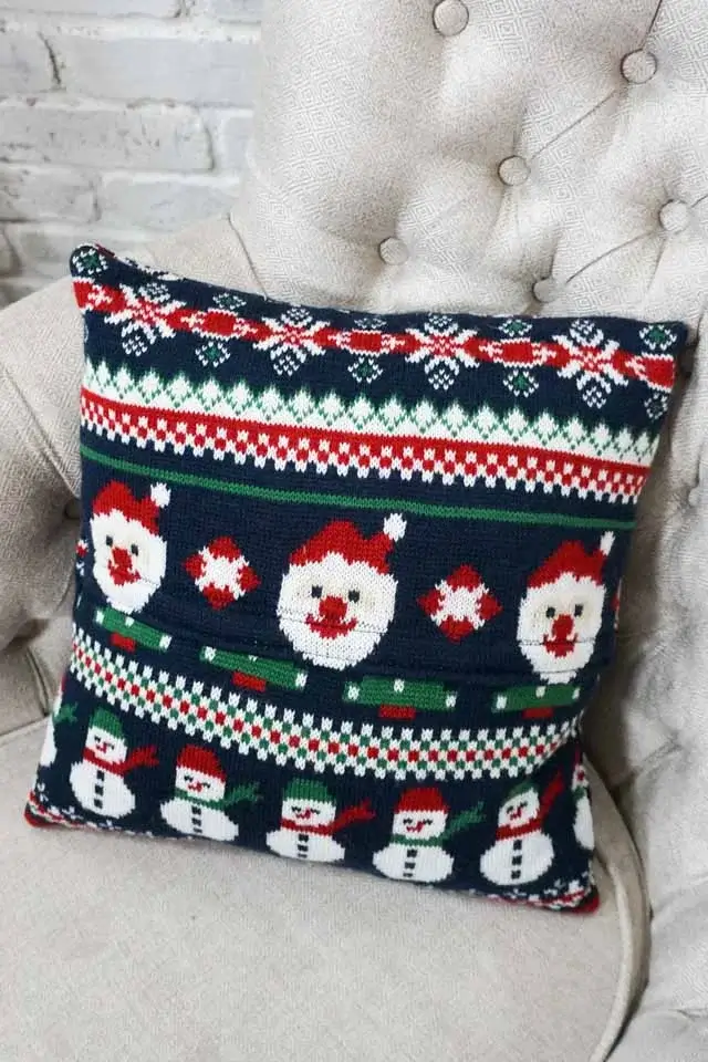 Cozy throw pillows with festive patterns made from upcycled Christmas sweaters, perfect apartment Christmas decor for adding holiday cheer to a couch.