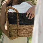 A Woman in Printed Dress Holding a Woven Basket