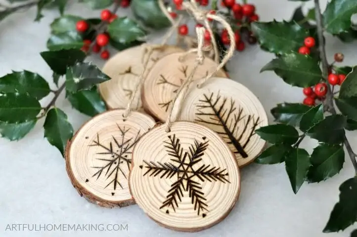 A collection of rustic tree ornament ideas burned on natural wood slices.