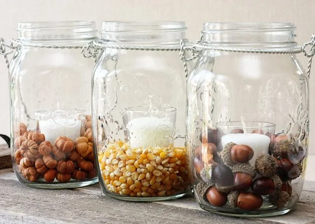 acorn and popcorn in mason jar with  candles as centerpieces