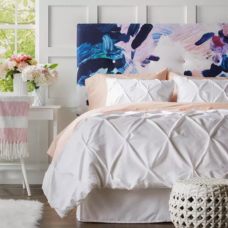 DIY tufted headboard in a bold pattern for a small bedroom.