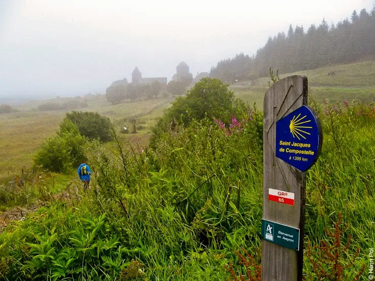 Wooden sign for the Chemin de St-Jacques, a classic slow travel pilgrimage trail in the French countryside