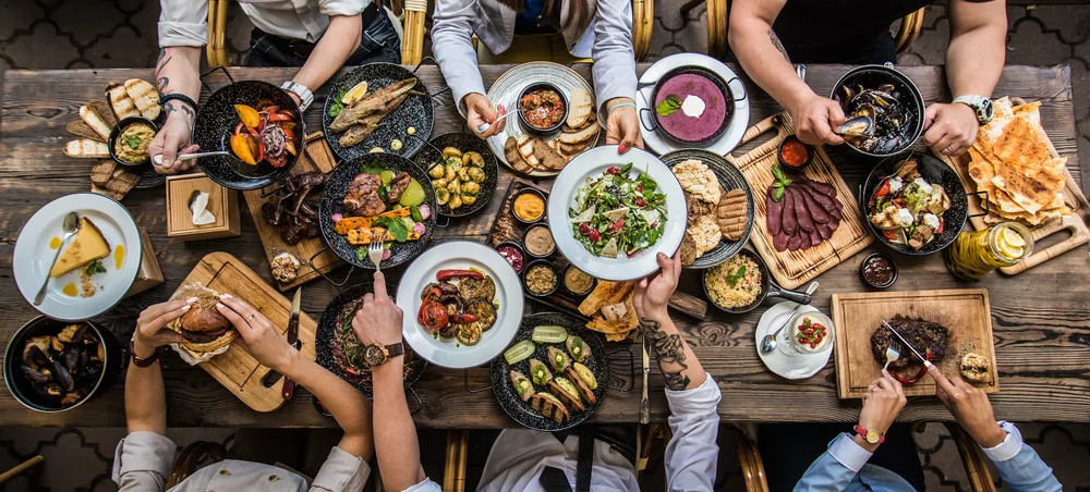 people enjoying potluck style dinner party