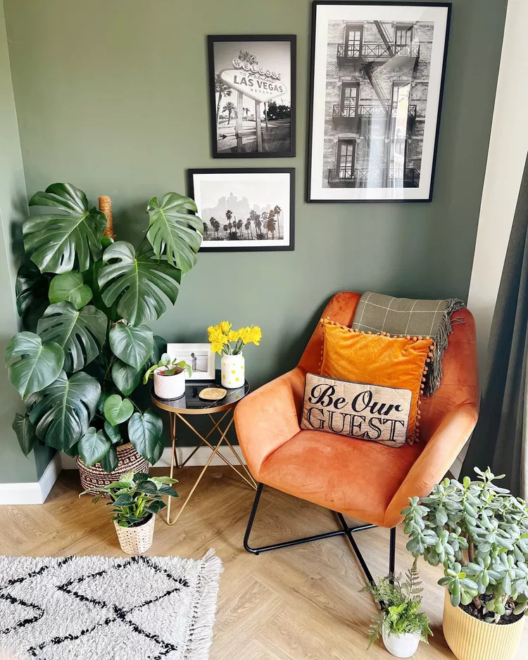 green wall in living room with orange rust colored chair