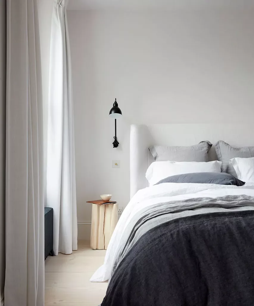 minimalist bedroom with single bedside lamp