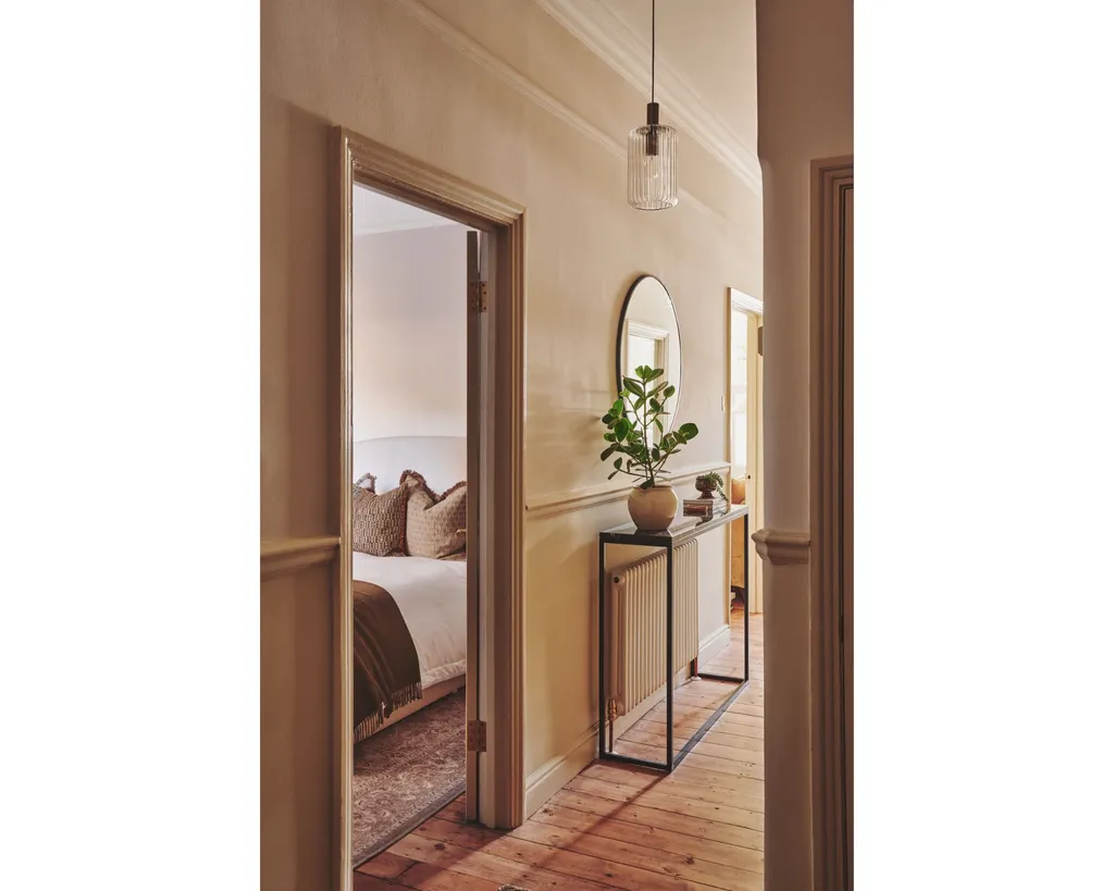 keep a small apartment clutter free with a console table in the hallway