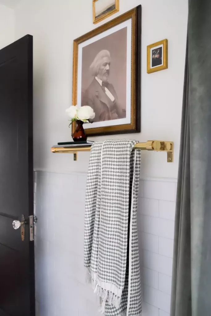 Vintage bathroom styled with brass accessories, soft lighting, and classic subway tiles.