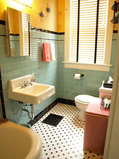 Retro bathroom decor combining classic elements like pedestal sinks and checkerboard floors