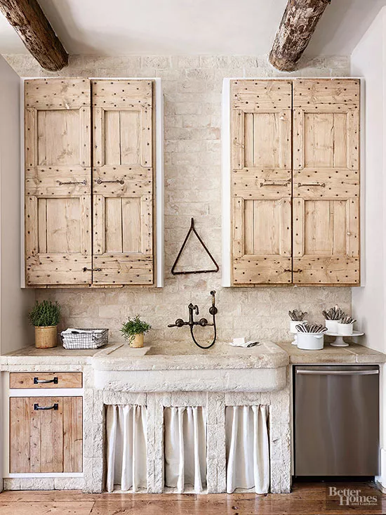 
rustic wood kitchen with linen curtains and reclaimed wood doors. 