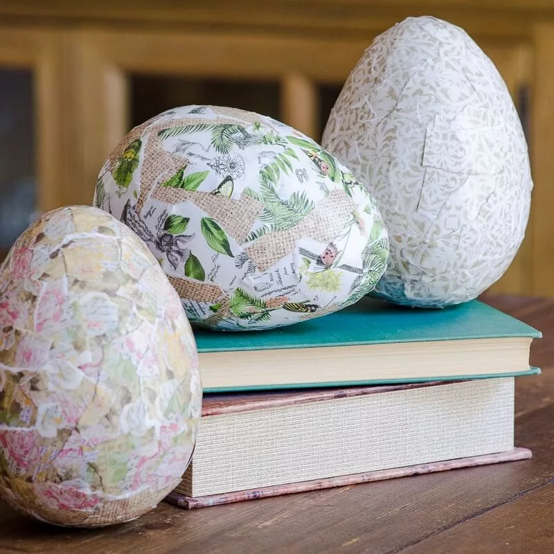 Handcrafted paper mâché Easter eggs, decorated with scrapbook paper and used as unique Easter decorations for the home, perfect for a DIY touch