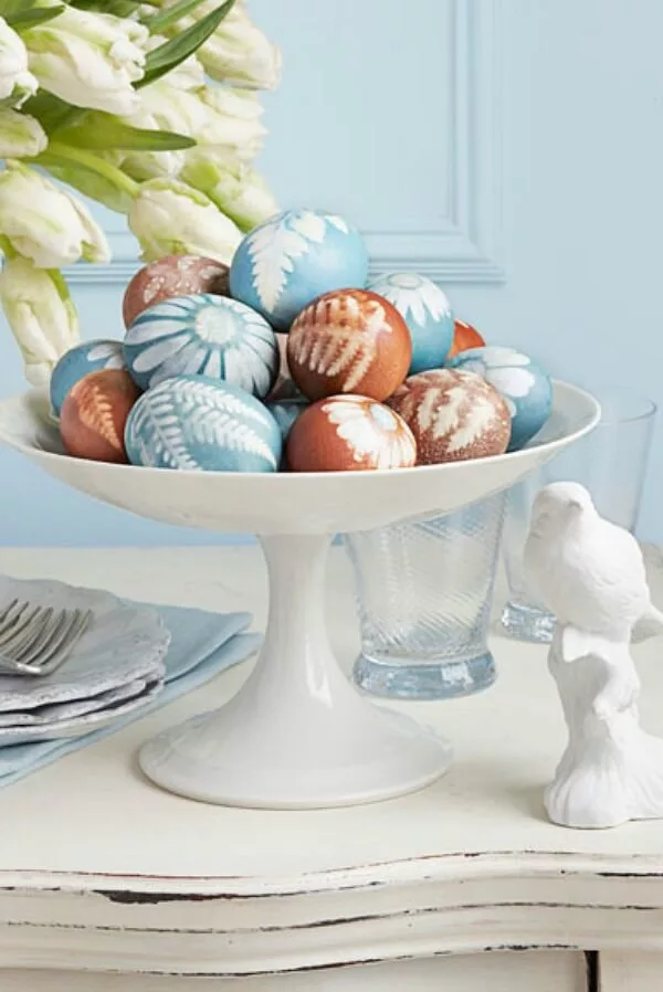 Nature-inspired dyed Easter eggs pressed with flowers, creating stunning, colorful Easter decorations for the home.