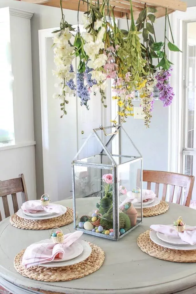 Charming Easter display with pastel egg decorations, bunny topiary, and hanging flowers, perfect for Easter Day decor and Pinterest Easter decorations.