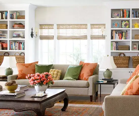 Living room shelves showcasing stylish decor pieces, books and storage baskets.
