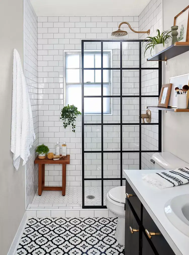 modern black and white bathroom with floating shelves with art and decor