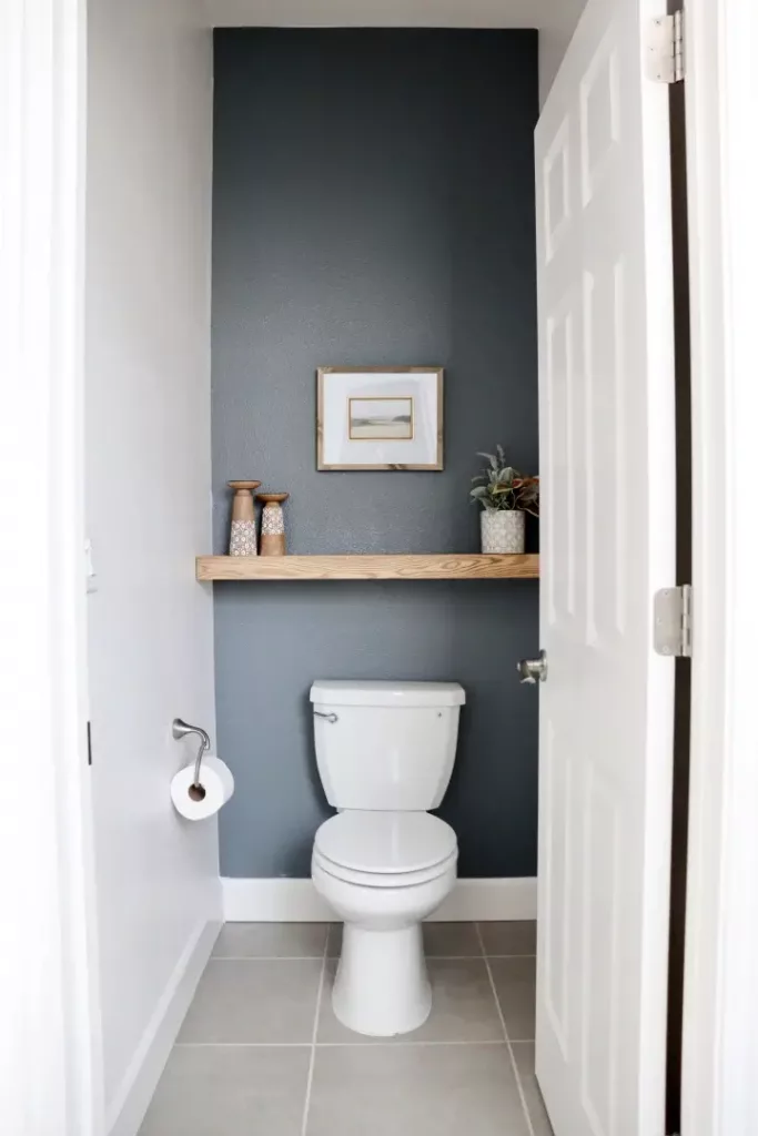 light wooden floating shelf above toilet