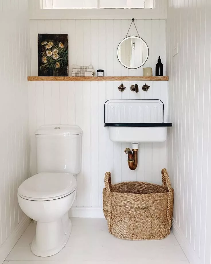 farmhouse toilet room with shelf about the toilet