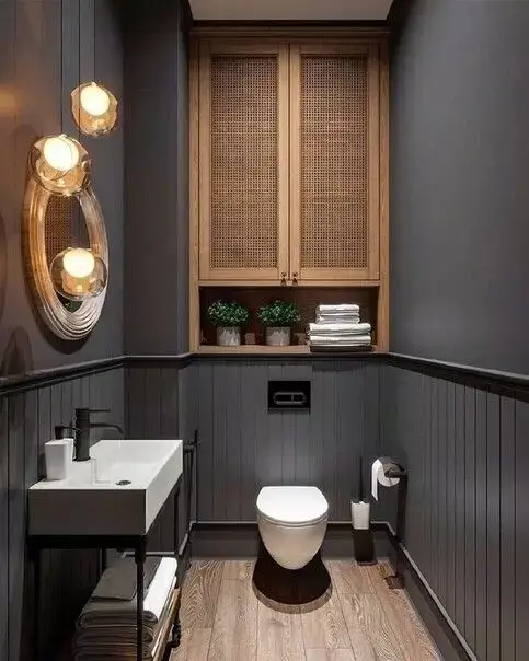 dark modern toilet room with a shelf about the toilet