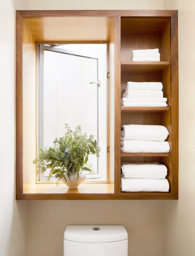 shelving framing window in small toilet room