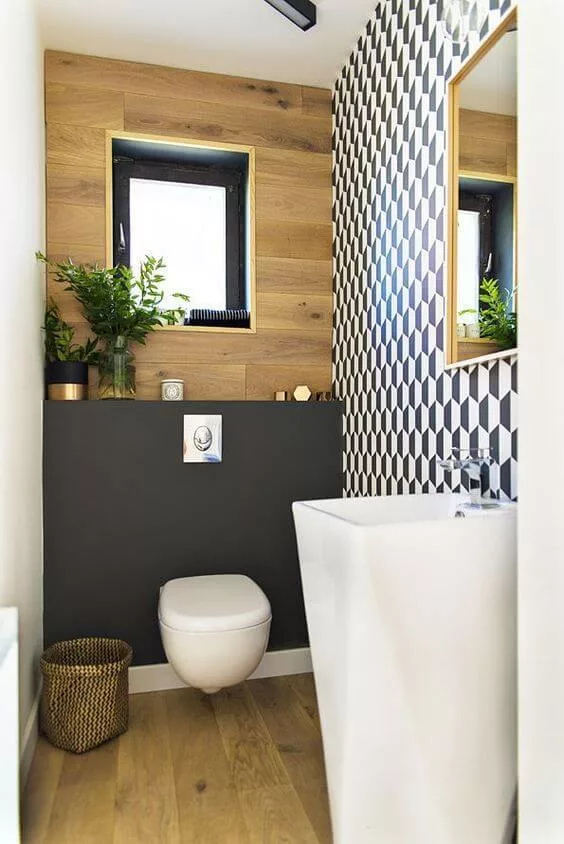 contemporary toilet room with decor on shelf above the toilet