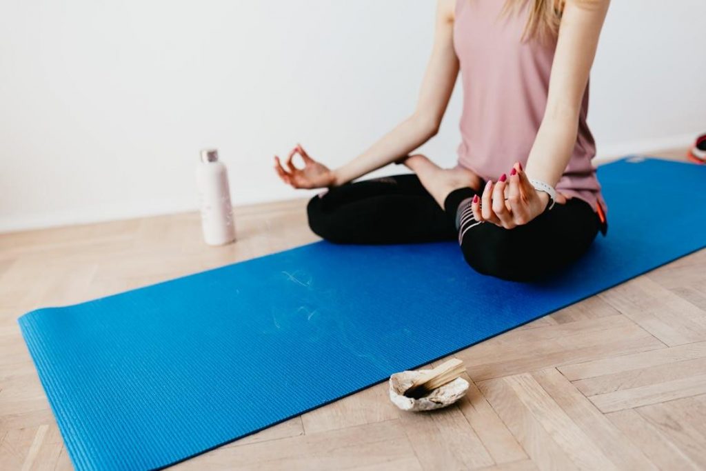 woman on yoga mat working out in a small space