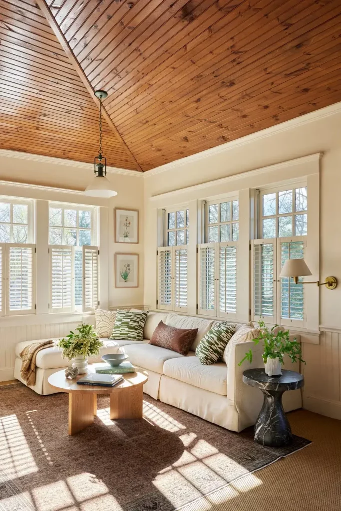 Trending warm toned ceiling colors through wood paneling, complementing neutral furniture
