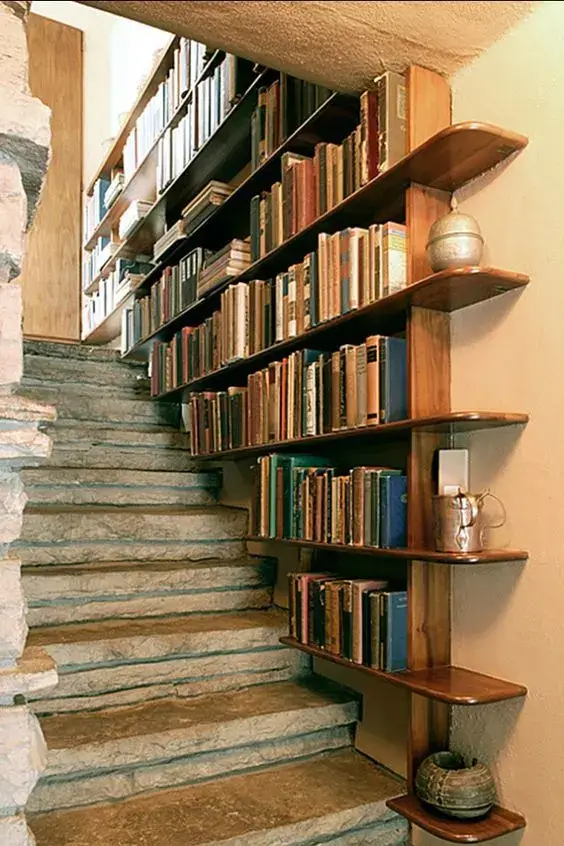 decorate staircase walls with functional bookcases or storage