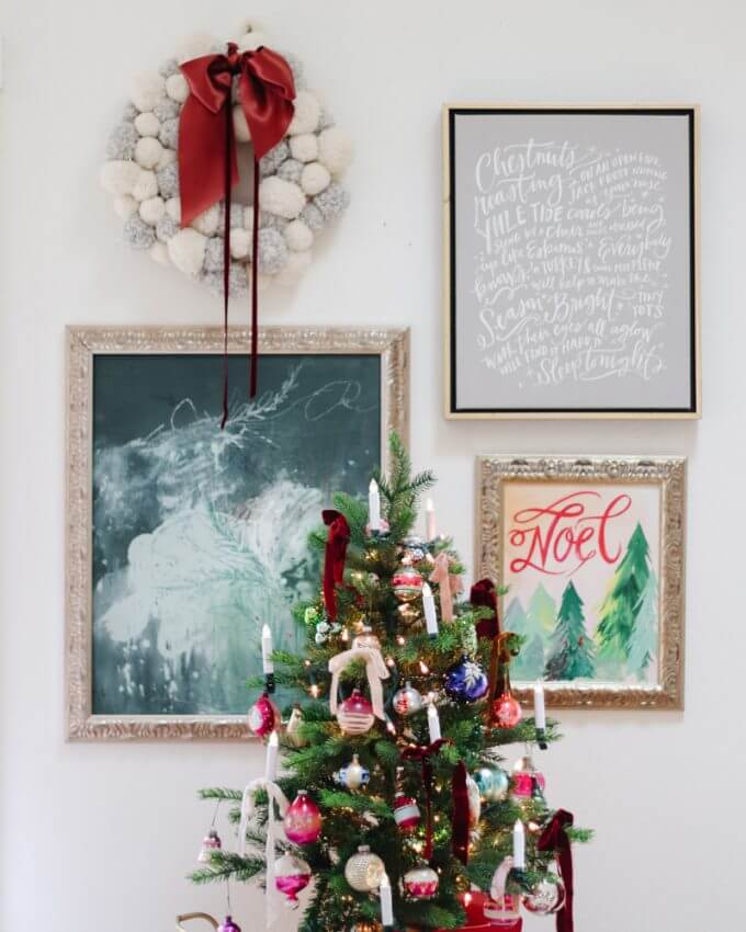 Christmas tree with both new and vintage ornaments. Plus framed christmas art some are modern christmas themed pieces and some are old greeting cards and vintage style christmas wall decor
