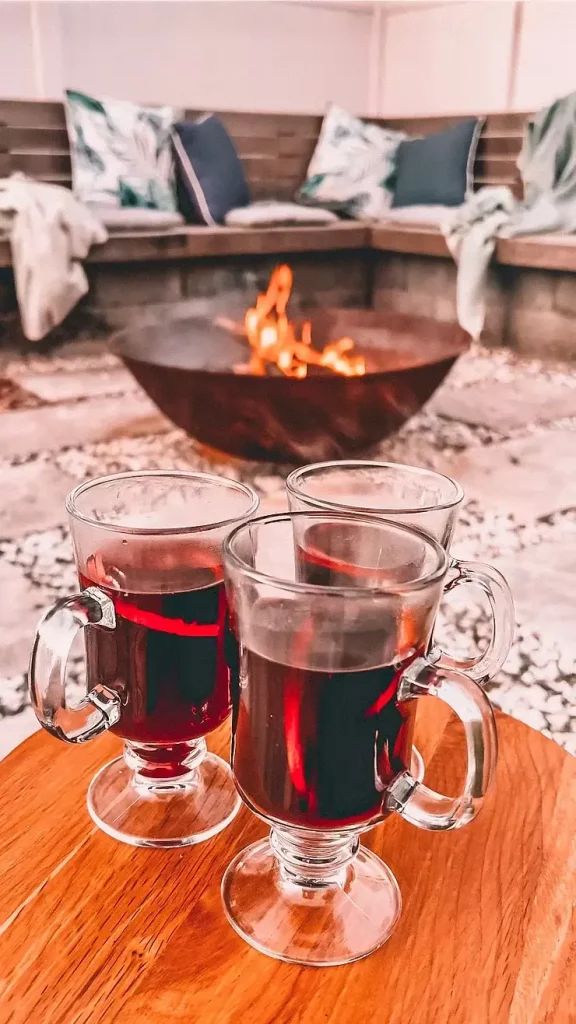 a cozy winter patio warmed with a firepit and mulled wine