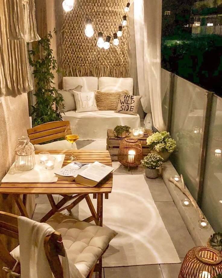 warm and cozy balcony with rugs and lights to define space for winter dinning.