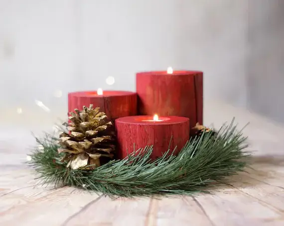 Rustic log candle holders on a side table, adding texture to a scandi house Christmas decor.