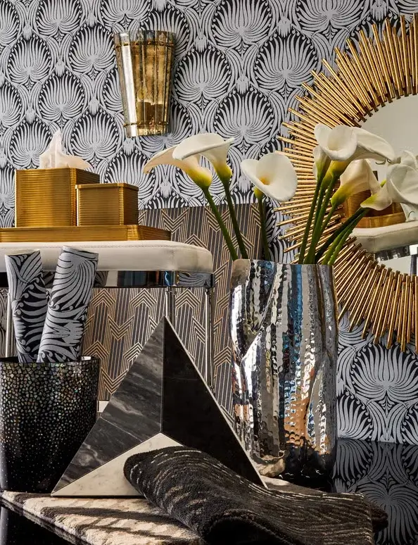 A luxurious space illustrating how a black and white room can feel opulent and warm with rich textures and metallics.
