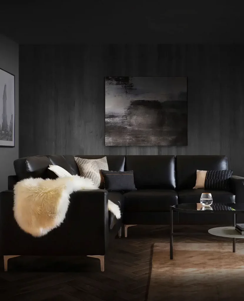 A moody black and white design in a living room using textures to add warmth