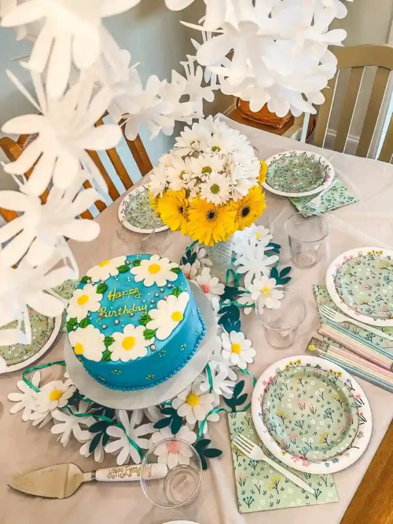 A birthday cake used as a simple centerpiece for a holiday party table in a small apartment.