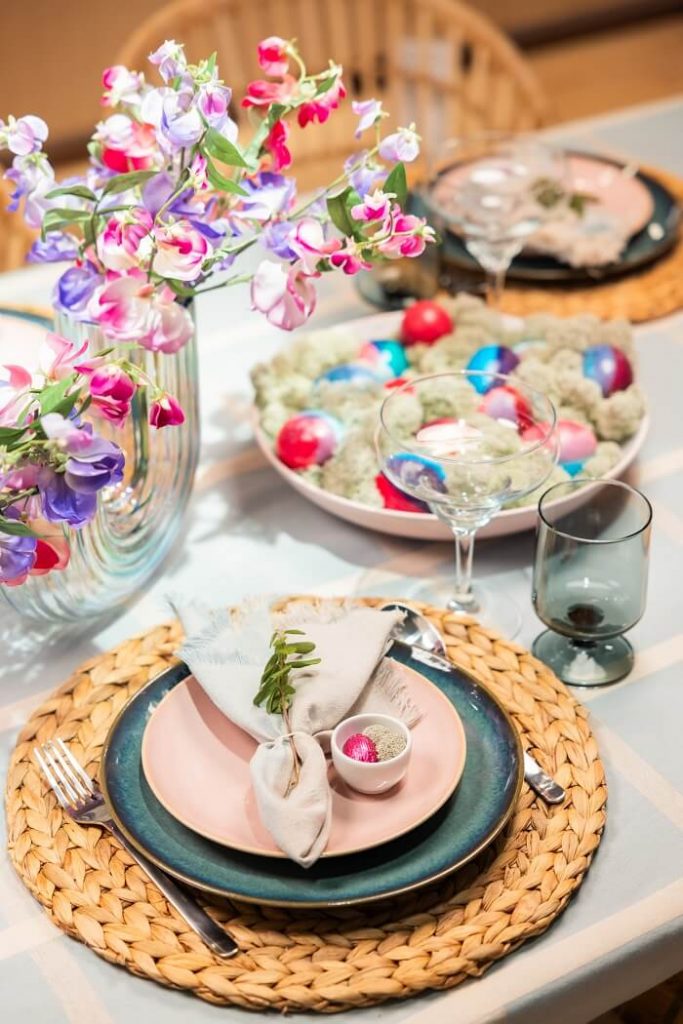 cohesive Easter table decor matching mini chocolate eggs with a floral centerpiece for a simple, joyful holiday table setting.
