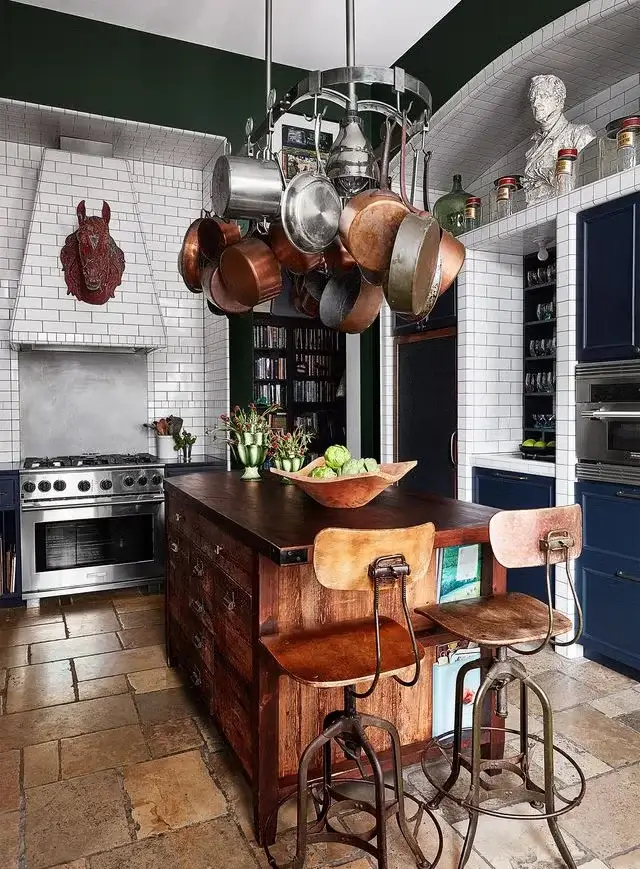 A single statement sculpture for the kitchen creates a focal point above the cabinets.
