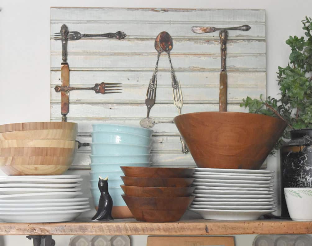 large wooden dough bowls add natural texture as part of minimalist above cabinet decor.