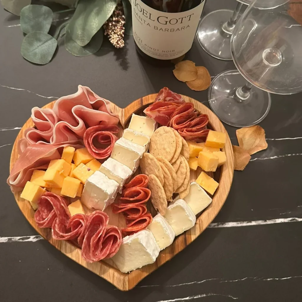 Heart-shaped grazing board centerpiece for Valentine’s table