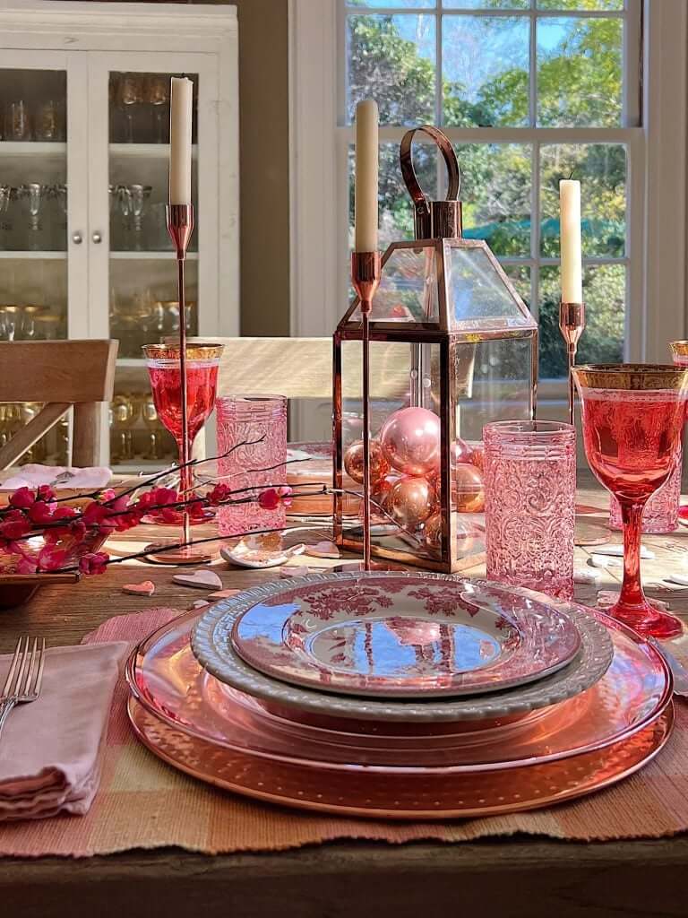 Pink glassware and blush plates for elegant Valentine’s table décor