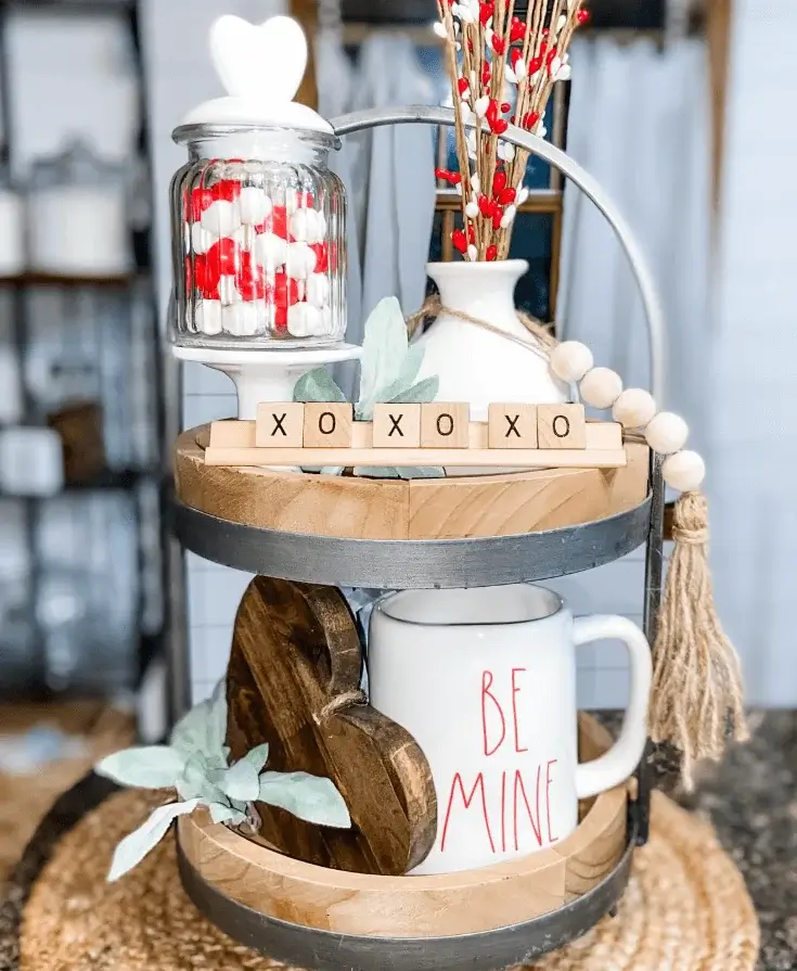 Cute Valentines tiered tray centerpiece styled with flowers and hearts