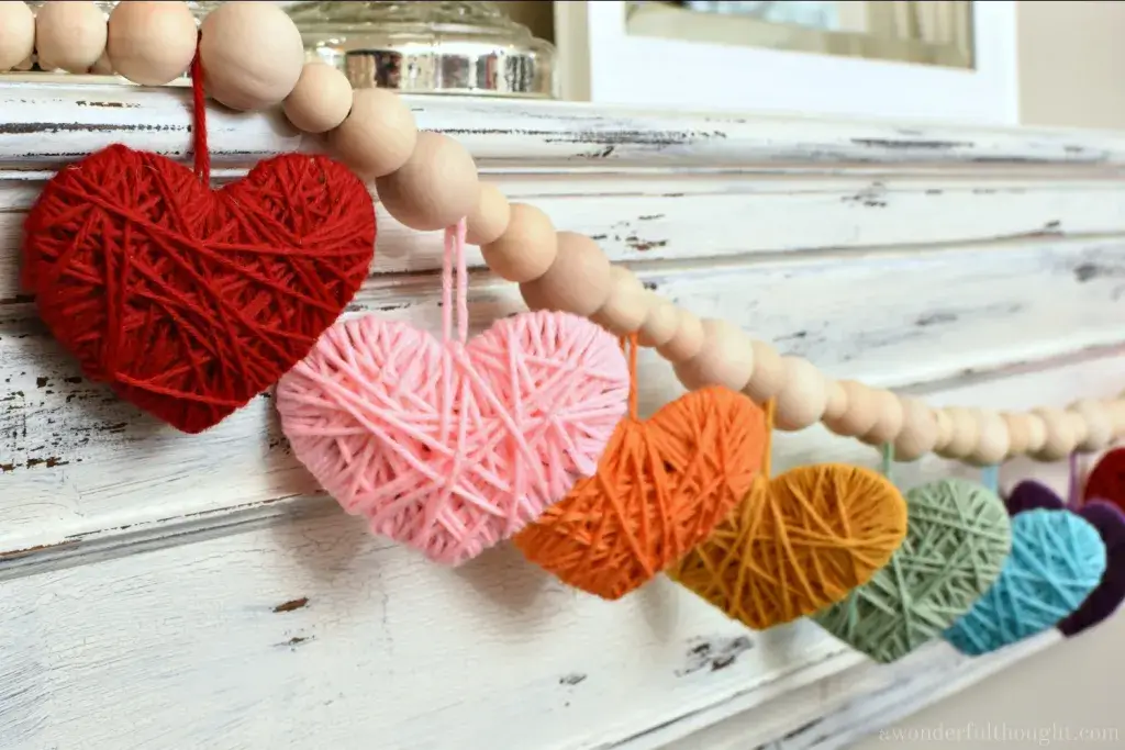 Yarn heart garland centerpiece for rustic Valentine’s table setting