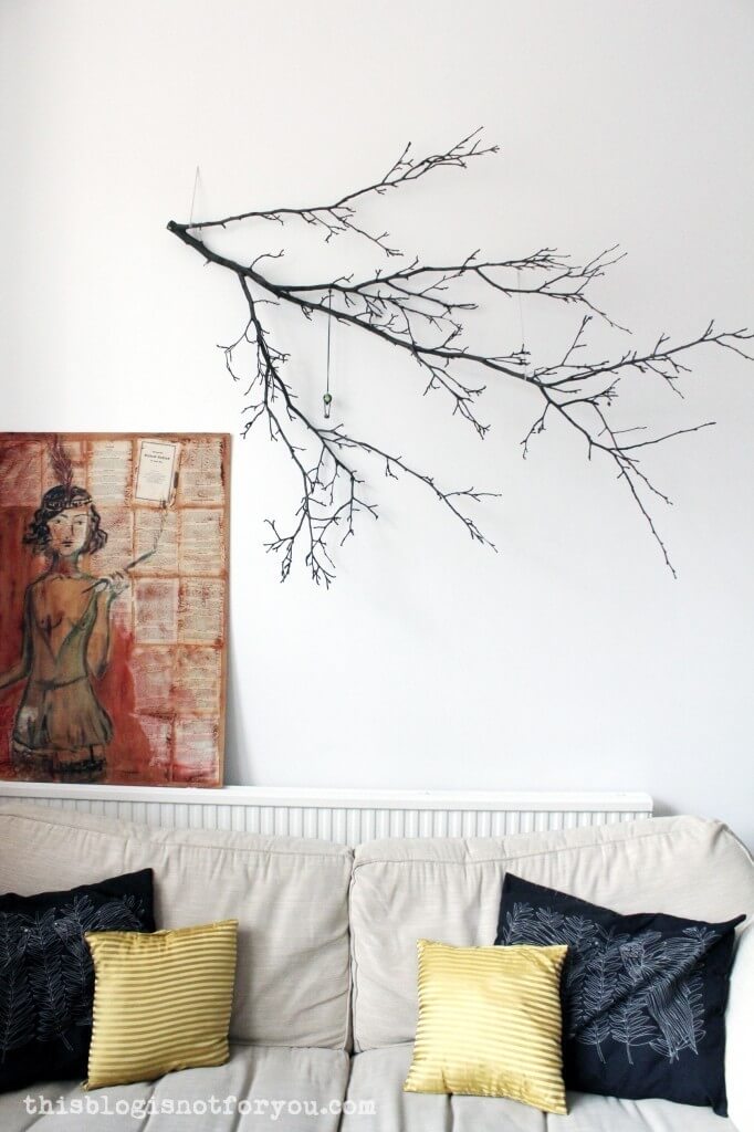 Minimalist biophilic design with a large sculptural branch as a statement natural element in interior design.