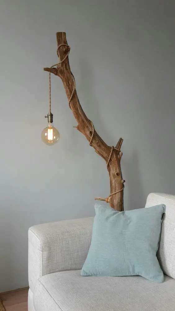 Branch statement lamp blending organic forms with industrial style, a key look in trending interior designs.
