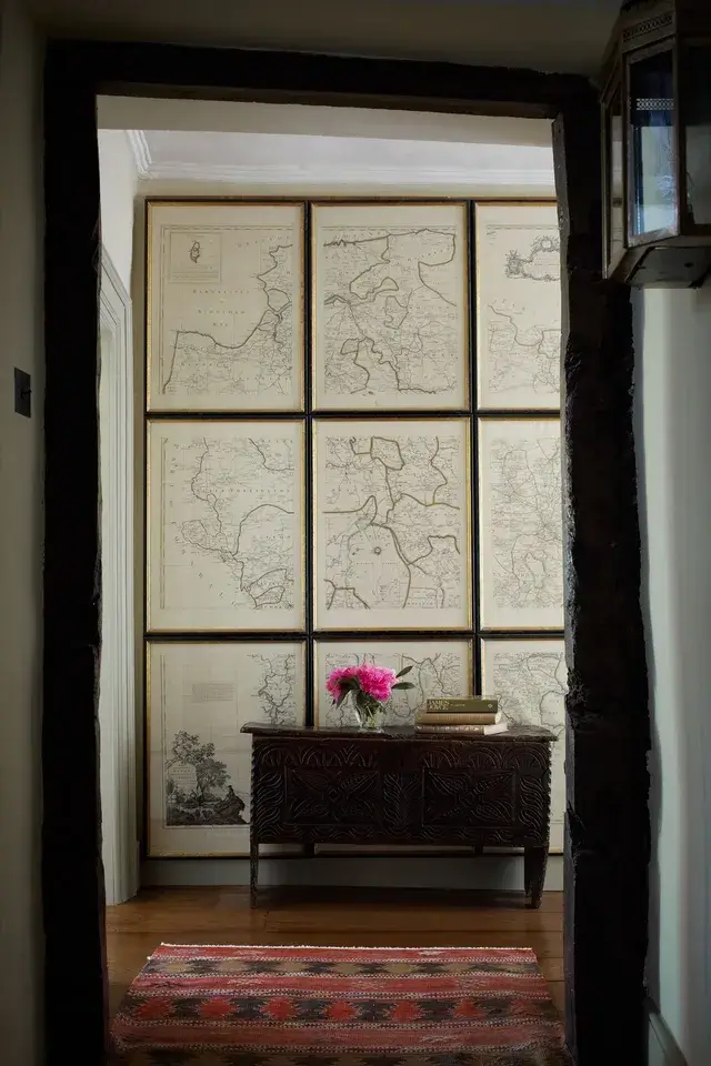 A sophisticated room uses multiple frames to display sections of one large map, creating a grand, unified display.