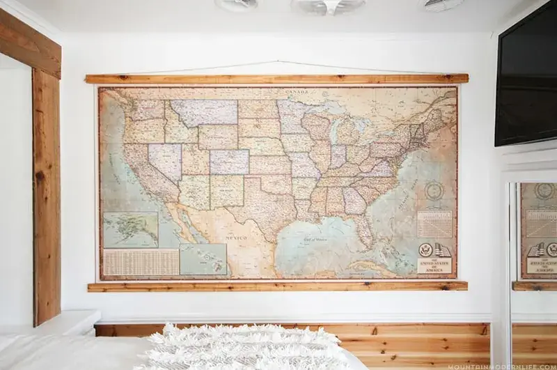 A stunning, floor-to-ceiling push pin travel map acting as a bold headboard.