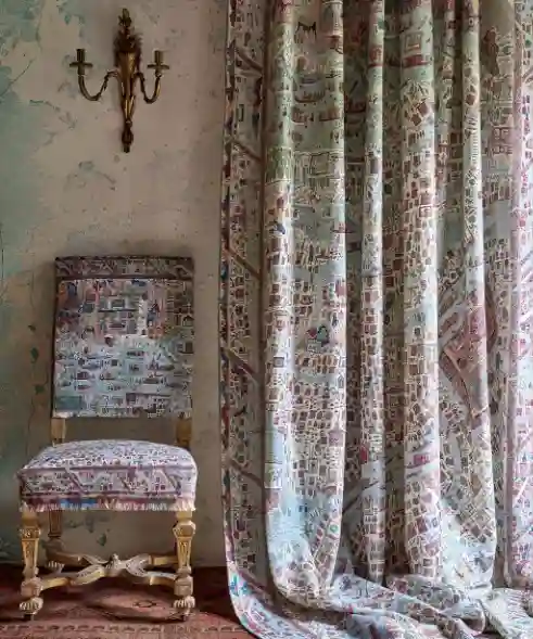 Curtains made from a fabric printed a map design frame a window, bringing the theme into soft furnishings.