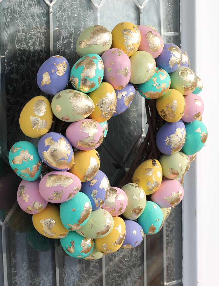 dyed and gold foiled eggs are used to create an easter door wreath